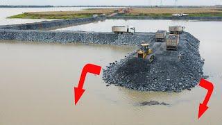 New Today Good Activities Road Construction With modern machinery pushing stone in water