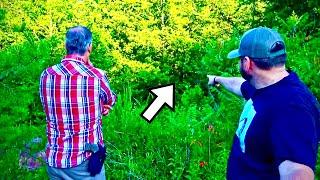 Bigfoot Standing in Front of Cave with Offspring Climbing Trees Around Us on Camera