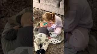 Big sister playing doctor with baby brother 
