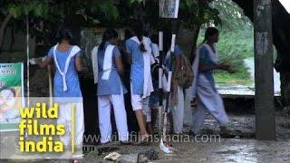 Village school girls wash off monsoon mud in Rajasthan