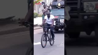 COLONEL MAMADI DOUMBOUYA OF GUINEA RIDING BICYCLE ON THE STREETS OF CONAKRY