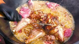 Chef prepares meaty Street Food in large Wood Oven  Street Food Berlin Germany