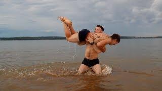 WRESTLING IN WATER two muscle brothers flexing and wrestling. And then have fun cliff jumps