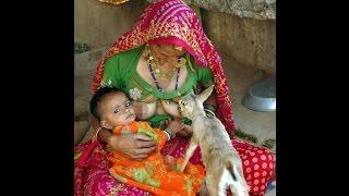 Woman breast feeds deer alongside her baby