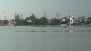 Residents of Vietnamese village near Hanoi return to clean up as floodwaters recede