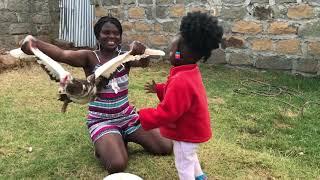 African village girl slaughtering Duck for food