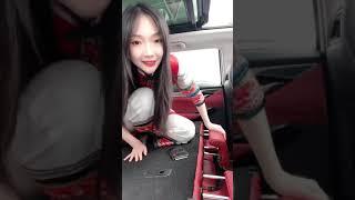 Chinese girl show her black nylon feet in car