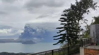 People view the erupting Taal volcano in Tagaytay City Philippines