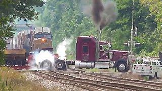 Semi truck stuck on train tracks with train coming  The truck got stuck on the railway tracks