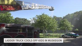 Muskegon first responders cooling kids off during hot weather