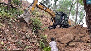 Mini Excavator Cutting Hillside with Rocks Boulders and Trees-Mountain Road Work