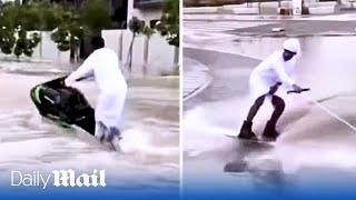 Thrill seeking Emiratis on jet skis swerve through Dubais flooded roads after heavy rains sink cars
