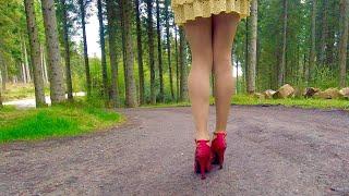 Crossdressing in tights and red heels.