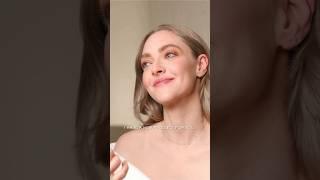 Amanda Seyfried in makeup chair with Genevieve Herr for Lancome event