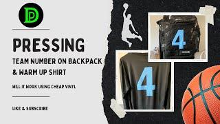 Pressing vinyl team number on backpack and warm up shirt.