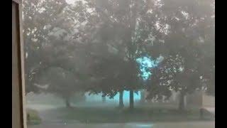 Glowing Blue Ionized Energy Arching Across a Power Line During a Storm