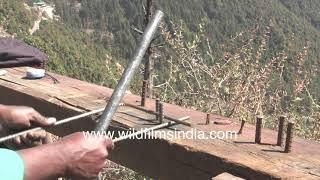 Bending iron rod by hand - Construction worker at work in North India