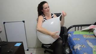 Awesome woman blowing balloon and makes sit pop