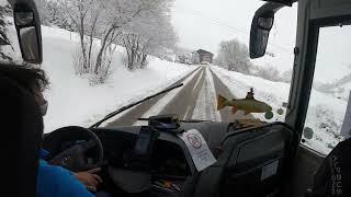 Bus driving downhill a snowy mountain French Alps