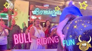 Girl in Blue Denim Dress Riding on a Mechanical Bull in Benidorm 4K