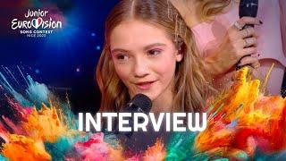 Zoé Clauzure on stage interview with Olivier Minne  Junior Eurovision 2023