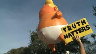 Inflatable baby Trump balloon hoisted near rally  AFP