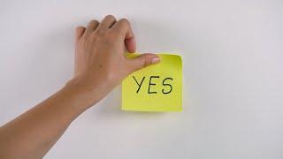 Closeup shot of womans hand sticking note with YES word on ...  Indian Stock Footage  Knot9