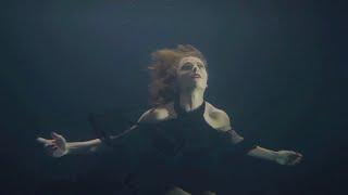 Beautiful Woman Performing Underwater in Black Dress