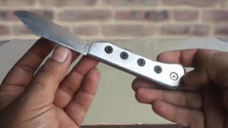 Making a pocket folding knife  from rusted leaf spring and Bimetal Band Saw Blade 