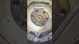 Many ways to hold the flywheel in place but this is the method I prefer