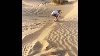 Surfing a Sand Dune in the Arabian Desert