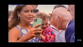 Joe Biden gets weird with toddler. Sniffing and biting WTF