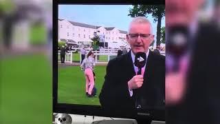 Hilarious moment naughty child is dragged away by his foot after interrupting live TV racing repor