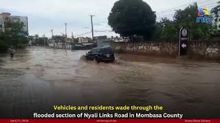 Vehicles and residents wade through the flooded section of Nyali Links Road in Mombasa County