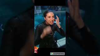 Lady emerges from pool in wet skin-tight wetsuit