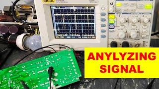 {969A} Analyzing signal on oscilloscope