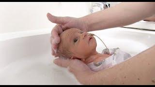 Babys first bath in NICU Swaddled