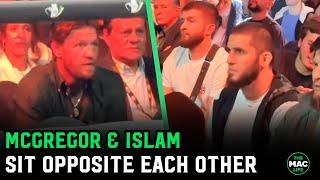 Conor McGregor and Islam Makhachev sit opposite each other at boxing event