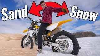 Dirt Bike With Paddle Tire Rips in Sand Dunes and Snow