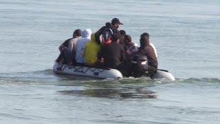 Migrants seen arriving on Kent beach in dinghy after crossing English Channel