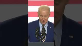 Joe Biden weirdly kicks podium
