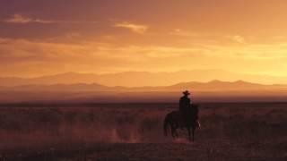 Slow motion shot of a cowboy riding a horse