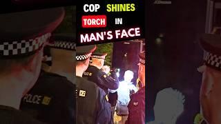COP SHINES TORCH in MANs FACE 