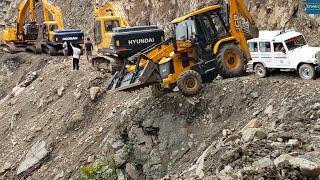 Excavators & Backhoes Open Mountain Road Clearing the Way for Waiting Vehicles