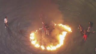 Oakland sideshow participants jump into ring of fire lit in intersection