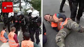 Pariser Polizei reißt festgeklebte Klima-Aktivisten von der Straße