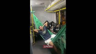 Guy chills in a hammock on a bus