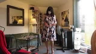 attractive mature crossdresser in a summer dress dancing showing slip