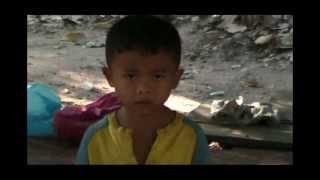 Khmer Boy Playing Traditional Music Cambodian child with instrument at Angkor Wat Cambodia