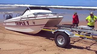 Trailer boating. How to load a ski boat onto a trailer on the beach. Cape Vidal